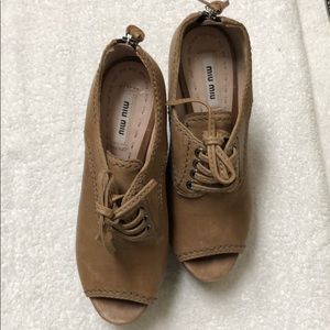 Miu Miu leather peep-toe zip back wedge bootie.